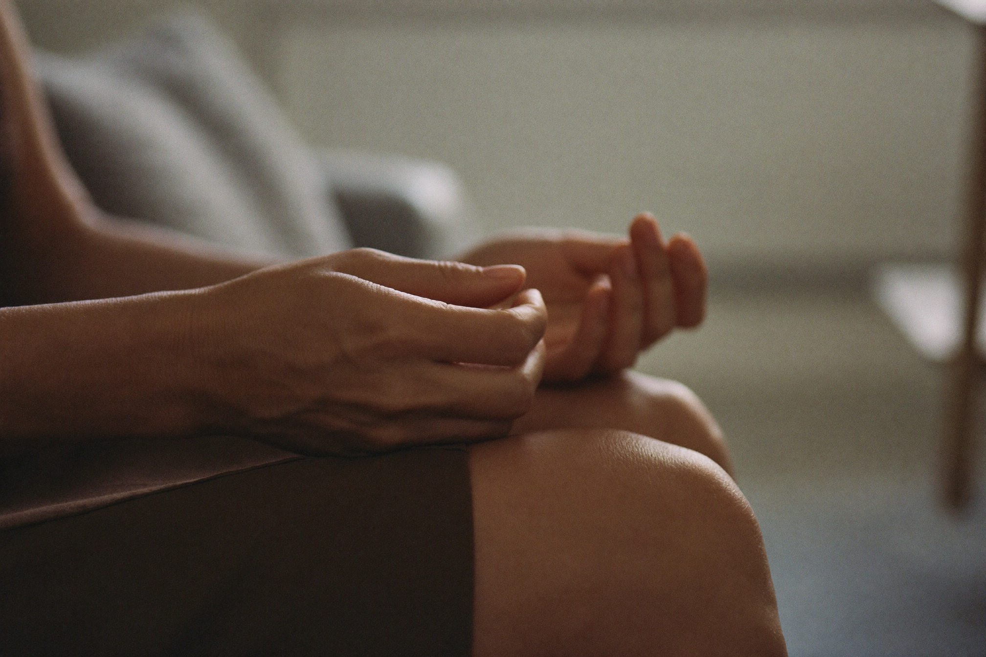 A woman's hands pressing her stiff, aching fingers