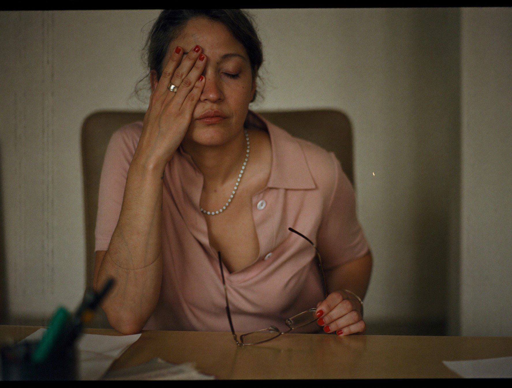A woman pressing her fingertips to her tired, dry eyes